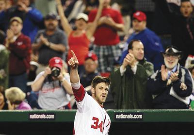 Haraz N. Ghanbari/AP
Outfielder Bryce Harper came out for a curtain call after hitting his first major league homer during the Nationals'win Monday.