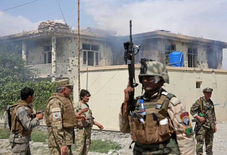 Afghan police officers arrive to the scene after Taliban fighters stormed a government building in Jalalabad, east of Kabul, Afghanistan, Monday, May 12, 2014. Taliban fighters stormed a government building in eastern Afghanistan after killing police guards on Monday, the most serious in a wave of attacks marking the start of the insurgents' annual spring offensive. In the Taliban heartland in the south, an attack on a police checkpoint in Helmand province killed many policemen.  (AP Photo/Rahmat Gul)