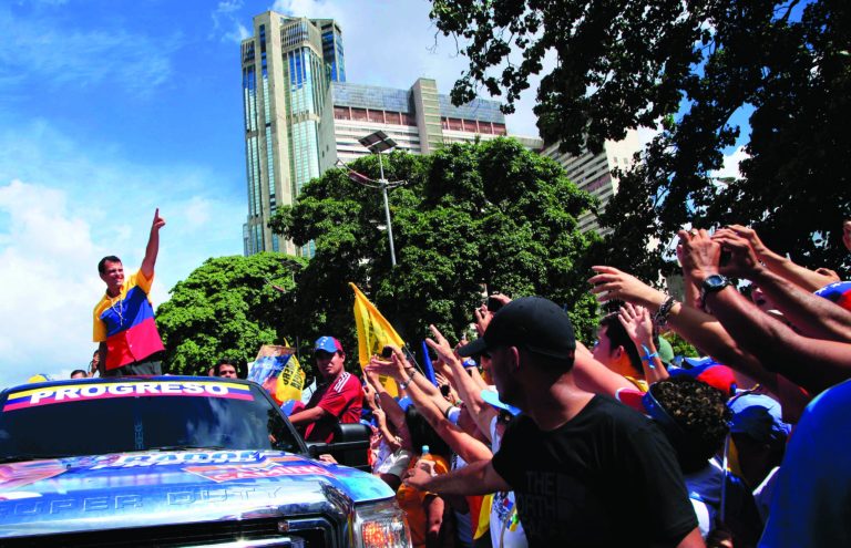 Opposition presidential candidate Henrique Capriles, top, gestures to supporters during a campaign rally in Caracas, Venezuela, Sunday, Sept. 30, 2012. Presidential elections in Venezuela are scheduled for Oct. 7. (AP Photo/Ariana Cubillos)