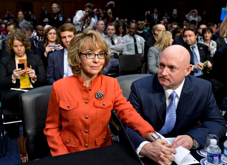 FILE - In this Jan. 30, 2013 file photo, former former U.S. Rep. Gabrielle Giffords, who survived a gunshot to the head in 2011, during a mass shooting in Tucson, Ariz., sits ready with her husband, retired astronaut Mark Kelly, at a Senate Judiciary Committee hearing on Capitol Hill in Washington to discuss legislation to curb gun violence. Giffords and Kelly are scheduled to be in Denver, Monday, March 4, 2013 to testify in support of at least one of the seven gun-control bills being considered by the Colorado Legislature. Eileen McCarron, president of the Colorado Ceasefire Capitol Fund, says Kelly will speak in support of a House bill that requires all private gun sales and transfers to be subject to a background check. (AP Photo/J. Scott Applewhite, File)