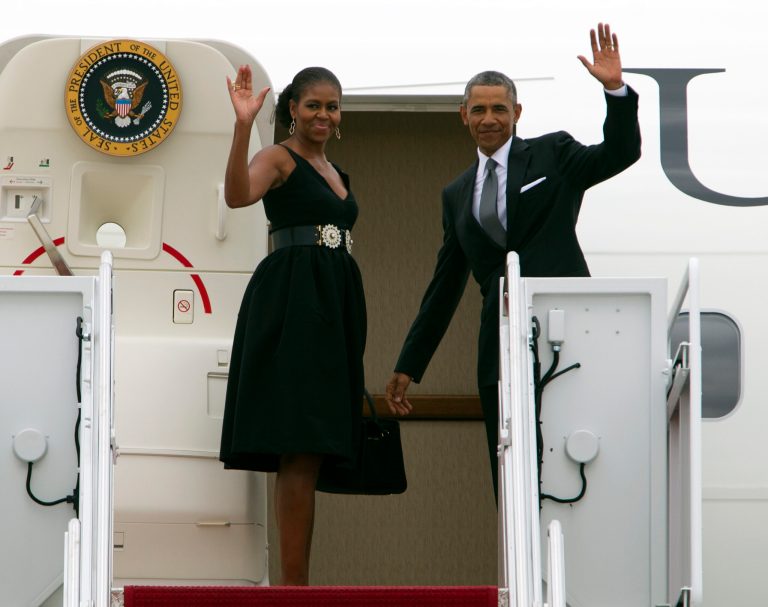 President Obama and first lady Michelle Obama wave as they board Air Force One at Andrews Air Force Base, Md., on Saturday, Aug. 30, 2014. The first family is attending the wedding of Sam Kass, their longtime family chef. The bride is MSNBC host Alex Wagner in Westchester County, north of New York City. (AP Photo/Jose Luis Magana)