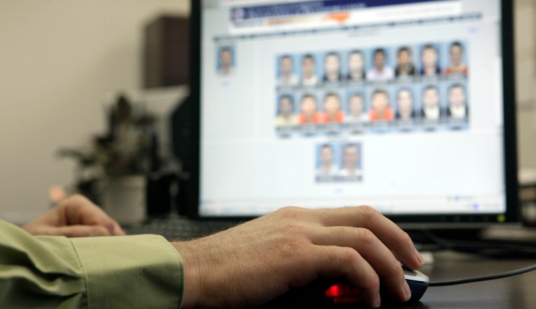 Stephen Lamm, supervisor with the ID Fraud Unit of the North Carolina Department of Motor Vehicles looks through photos in the facial recognition system Thursday, Sept. 24, 2009 in Raleigh, N.C.