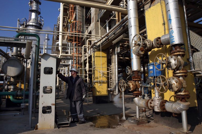 Tehran's oil refinery supervisor Jafar Jaleh Rafati, works at a unit of the refinery, south of the capital Tehran, Iran, Monday, Dec. 22, 2014. An Iranian official participating in talks on limiting his country's nuclear program said Tuesday that international negotiators have agreed to lift sanctions on Iran's oil, gas and banking sectors as soon as a deal is implemented. (AP Photo/Vahid Salemi)