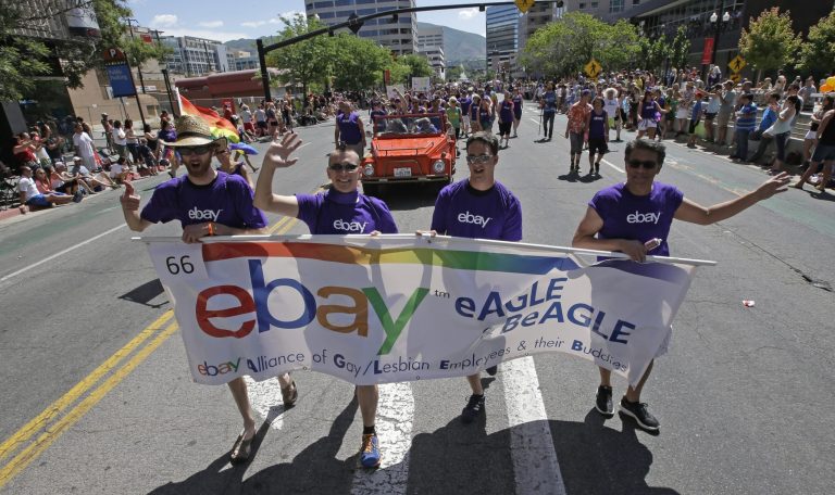 In this June 8, 2014, photo, workers carry an eBay banner during the gay pride parade, in Salt Lake City. Corporations have increased visibility this summer at gay pride parades around the country as same-sex marriage bans fall in the courts and polls show greater public acceptance of gay marriage. (AP Photo/Rick Bowmer)