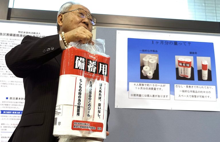 Satoshi Kurosaki, an industry executive who is leading the toilet pear campaign, shows the emergency stock toilet paper at Ministry of Economy, Trade and Industry during an event marking Mondayâs national disaster prevention day in Tokyo, Monday, Sept. 1, 2014. On national disaster prevention day, Japanâs government is urging people to stock up on toilet paper, because more than 40 percent of the nation's supply comes from a high-risk earthquake zone. (AP Photo/Mari Yamaguchi)