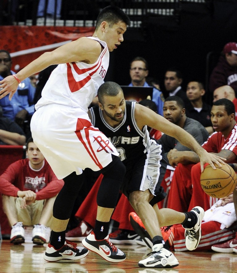   San Antonio Spurs' Tony Parker, right, pushes against Houston Rockets' Jeremy Lin in the first half of an NBA basketball game, Monday, Dec. 10, 2012, in Houston. (AP Photo/Pat Sullivan)  