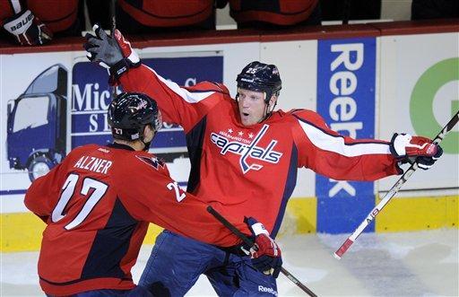 Washington Capitals left wing Jason Chimera, right, celebrates his goal with teammate Karl Alzner (27) during the second period of an NHL hockey game against the Carolina Hurricanes, Saturday, Oct. 8, 2011, in Washington. (AP Photo/Nick Wass)