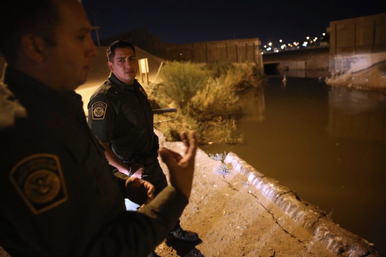 Border Patrol agents look for footprints along the highly polluted New River which crosses from Mexico into the United States and forms part of the U.S.-Mexico border on November 15, 2013 in Calexico, Calif. The river and border fence separate the large Mexican city of Mexicali with Calexico, and is a frequent illegal crossing point for immigrant smugglers. (Photo by John Moore/Getty Images)