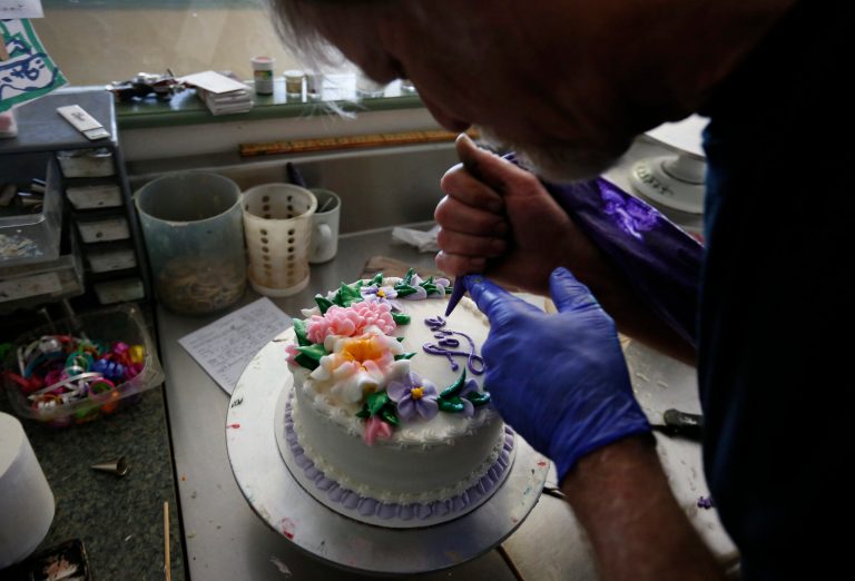 Masterpiece Cakeshop owner Jack Phillips decorates a cake inside his store, in Lakewood, Colo. (AP Photo/Brennan Linsley)