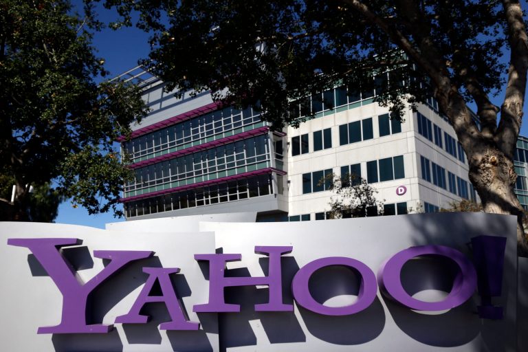 FILE - This Oct. 17, 2012, photo, shows a sign in front of Yahoo! headquarters in Sunnyvale, Calif. Yahoo says the government threatened to fine the company $250,000 a day if it did not comply with demands to go along with an expansion of U.S. surveillance laws by surrendering online information, a step the company regarded as unconstitutional. (AP Photo/Marcio Jose Sanchez, File)