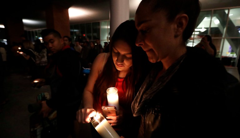 Virginia, right, and Natalie Ramos light candles as students from University of Nevada Las Vegas hold a vigil Monday, Oct. 2, 2017, in Las Vegas. A gunman on the 32nd floor of the Mandalay Bay casino hotel rained automatic weapons fire down on the crowd of over 22,000 at an outdoor country music festival Sunday. (AP Photo/Gregory Bull)