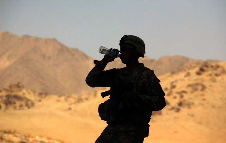 U.S. Army Pfc. Francisco Guzman, 22, from Aransas Pass, Texas, drinks water after reaching the crest of a hill with others from 4th Battalion, 25th Field Artillery Regiment from Fort Drum, N.Y., as they investigate a rocket attack on their combat outpost in the Jalrez Valley in Afghanistan's Wardak Province on Thursday, Sept. 24, 2009. (AP Photo/Maya Alleruzzo)