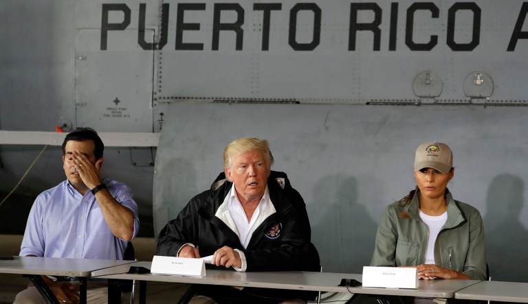 President Donald Trump talks about recovery efforts after he and first lady Melania Trump arrived at Luis Muniz Air National Guard Base to survey hurricane damage, Tuesday, Oct. 3, 2017, in San Juan, Puerto Rico, as Puerto Rico Gov. Ricardo Rossello, left, looks on. (AP Photo/Evan Vucci)