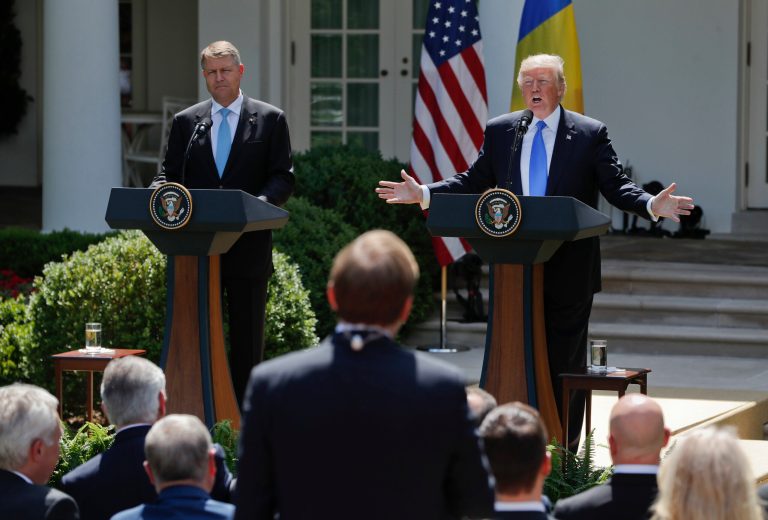 President Donald Trump, right, answers questions from Jonathan Karl, center standing, ABC News' Chief White House Correspondent, during a joint news conference with Romanian President Klaus Werner Iohannis, left, in the Rose Garden of the White House in Washington, Friday, June 9, 2017. (AP Photo/Pablo Martinez Monsivais)