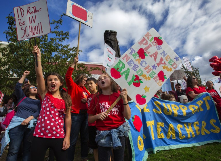 Sydney Stumpf, left, and Aderyn Kee, both students at Loyal Heights Elementary School, protest after marching with parents, students and supporters of teachers from Pioneer Square to the John Stanford Center, Tuesday, Sept. 15, 2015, in Seattle. (Ellen M. Banner/The Seattle Times via AP)