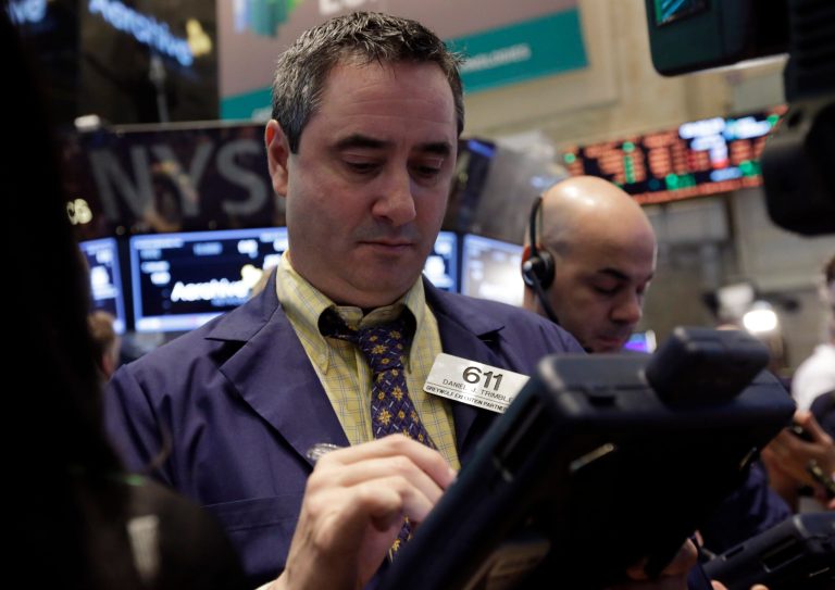 Trader Daniel Trimble, left, works on the floor of the New York Stock Exchange Friday. (AP Photo/Richard Drew)