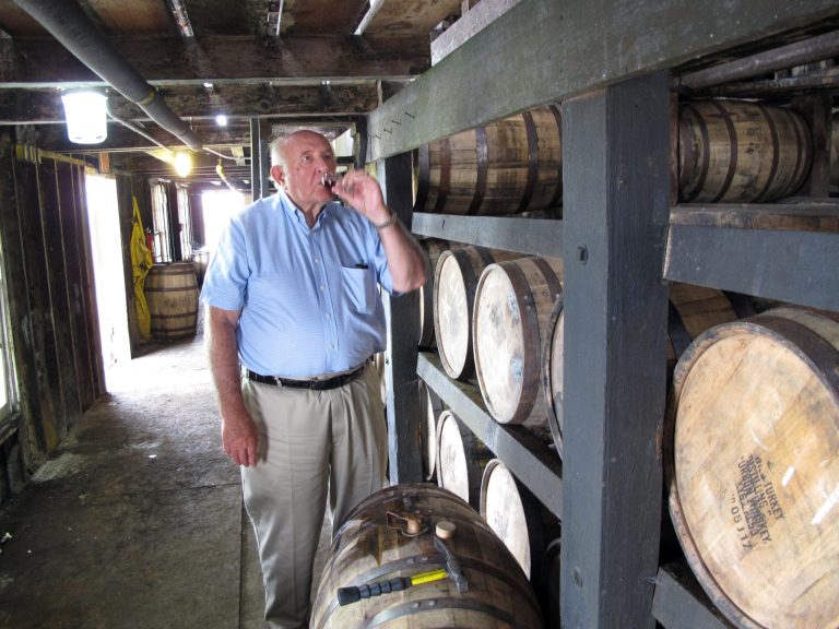 In this Aug. 22, 2014 photo, Wild Turkey master distiller Jimmy Russell takes a sip of bourbon drawn from the barrel at a warehouse near Lawrenceburg, Ky. Russell is celebrating his 60th year in the bourbon-making business. (AP Photo/Bruce Schreiner)