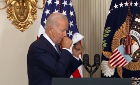 Biden takes off mask to cough