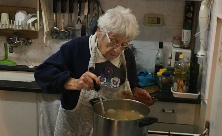 Ditza Heiman, 84, making soup with her family.