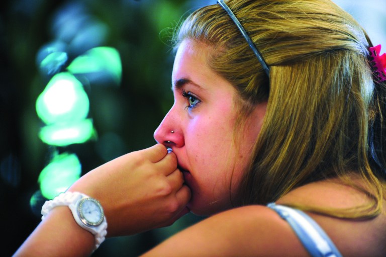 Penn State student Jessica Knoll begins to cry as she watches the televised news conference held by former FBI director Louis Freeh after the release of his report on the Jerry Sandusky child sex abuse scandal in the HUB building on the main campus in State College, Pa., Thursday, July 12, 2012. Freeh's investigation found that senior Penn State officials, including Hall of Fame football coach Joe Paterno, 