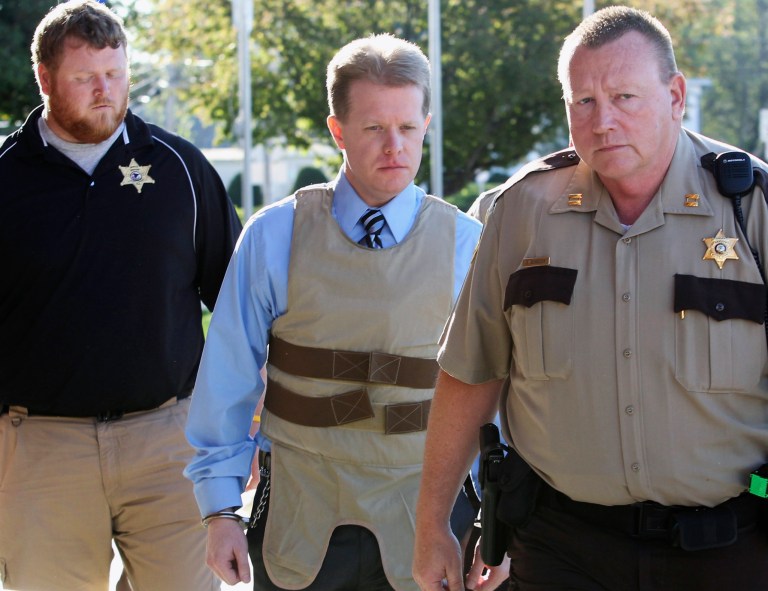FILE - In this April 12, 2011 file photo, murder suspect Christopher Coleman, center, is escorted to the Perry County Courthouse in Pinckneyville, Ill., during his trial. On Tuesday, Aug. 12, 2014, an Illinois appeals court reinstated the wrongful-death lawsuit claiming Joyce Meyer Ministries should have done more to prevent Coleman from killing his family. Coleman strangled his wife and two sons inside the family's Columbia home in 2009. It was filed on behalf of the family of Sheri Coleman, Christopher Coleman's wife. (AP Photo/The Belleville News-Democrat, Derik Holtmann, File)