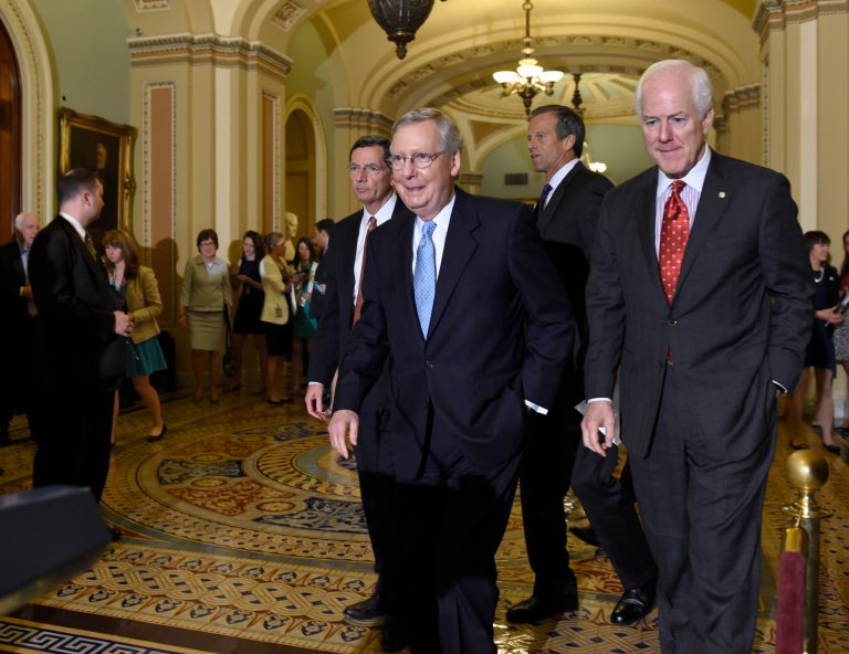 Senate Majority Leader Mitch McConnell of Ky., second from left, walks to the podium to speak to reporters following the weekly Republican luncheon on Capitol Hill in Washington, Tuesday, June 16, 2015. Joining McConnell are, from left, Sen. John Barrasso, R-Wy., Sen. John Thune, R-S.D., and Sen. John Cornyn, R-Texas. (AP Photo/Susan Walsh)