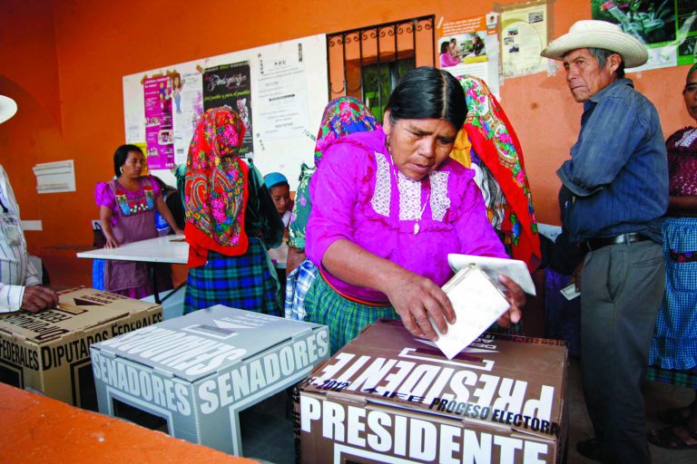A woman casts her ballot at a polling station in Oaxaca, Mexico, Sunday, July 1, 2012. Mexico's more than 79 million voters head to the polls Sunday to elect a president, who serves one six-year term, as well as 500 congressional deputies and 128 senators. (AP Photo/ Luis Alberto Cruz)