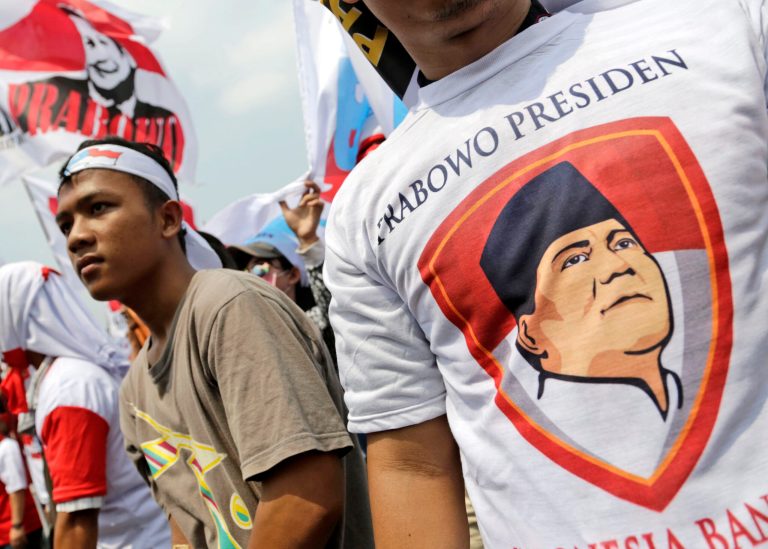 A supporter of losing presidential candidate Prabowo Subianto wears a T-shirt with writing reading 