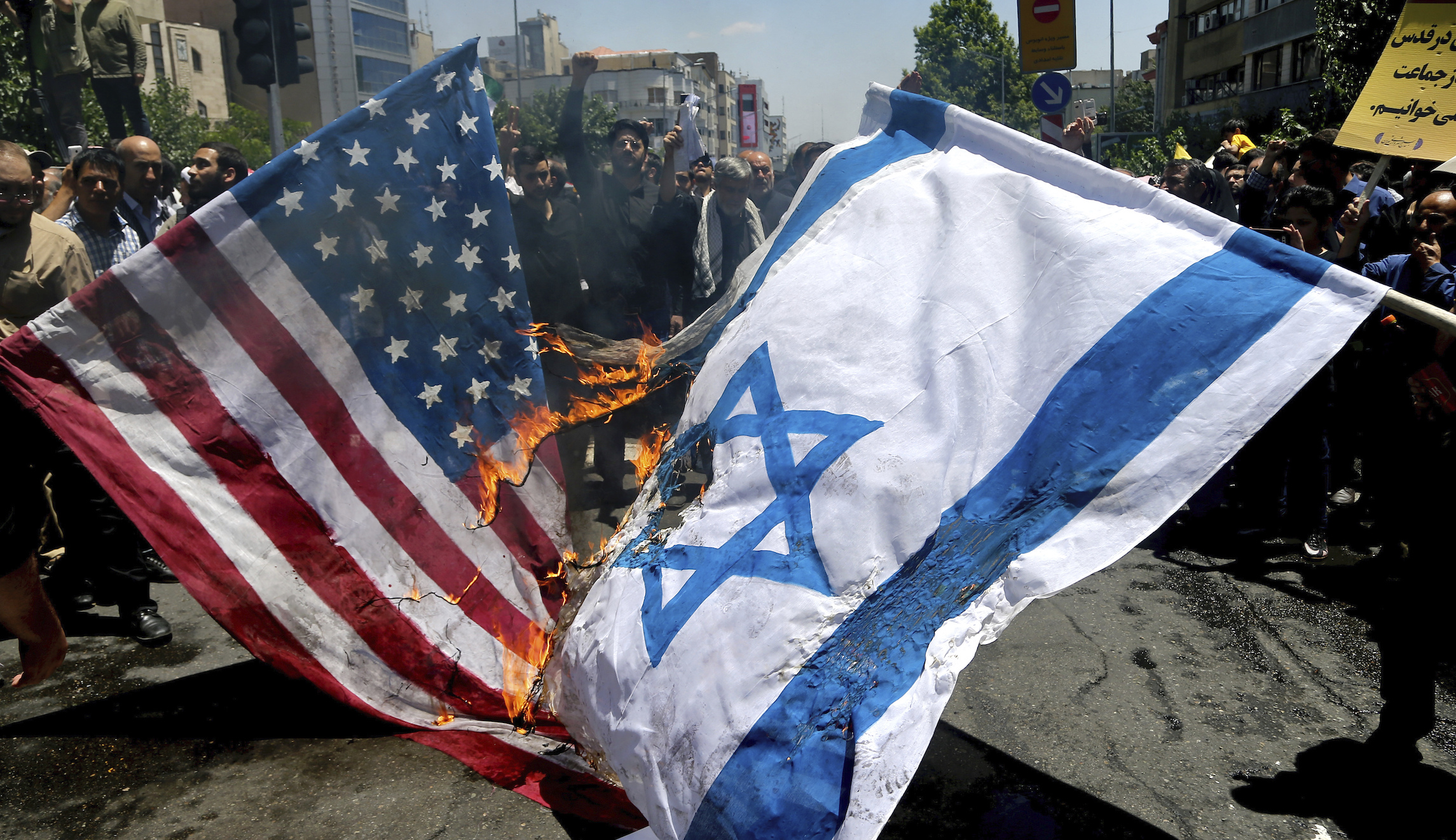 Iranian factory profits as protesters burn thousands of US and Israeli flags