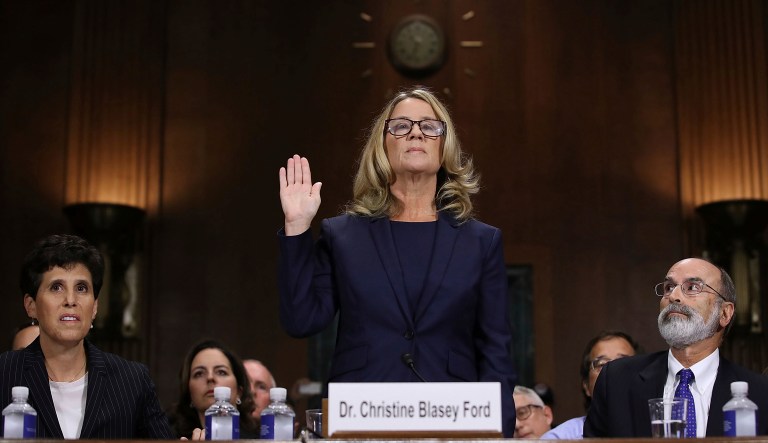Christine Blasey Ford is sworn in before the Senate Judiciary Committee, Thursday, Sept. 27, 2018 in Washington. Her attorney's Debra Katz and Michael Bromwich watch.