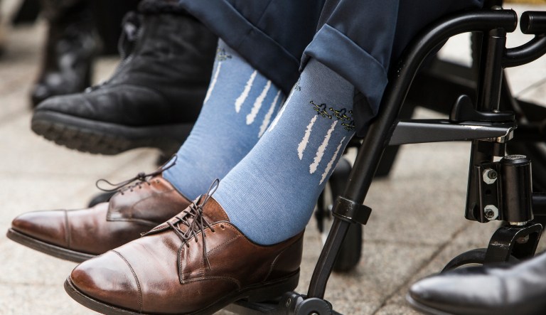 Former President George H.W. Bush wears socks depicting military jets flying in formation during a Pearl Harbor remembrance ceremony at the George Bush Presidential Library in College Station, Texas on Dec. 7, 2016.