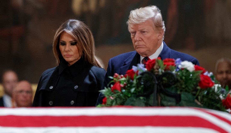 President Trump and first lady Melania Trump have a moment of silence at the flag-draped casket of former President George H.W. Bush in the Rotunda of the Capitol in Washington, Monday, Dec. 3 2018.