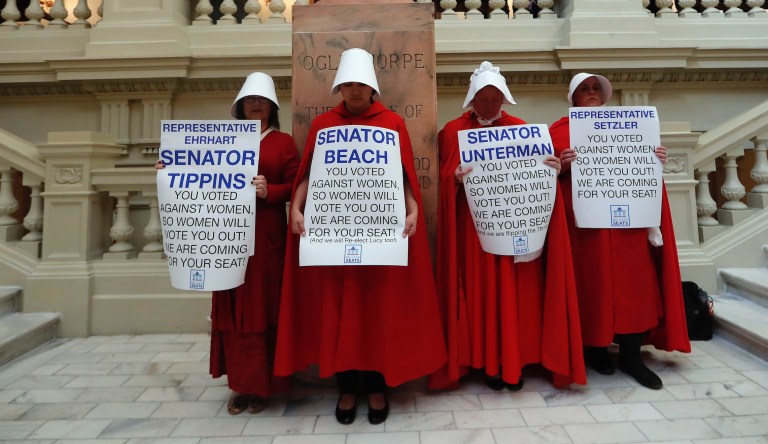 Women hold signs to protest HB 481 at the state Capitol, Tuesday, April 2, 2019, in Atlanta. 