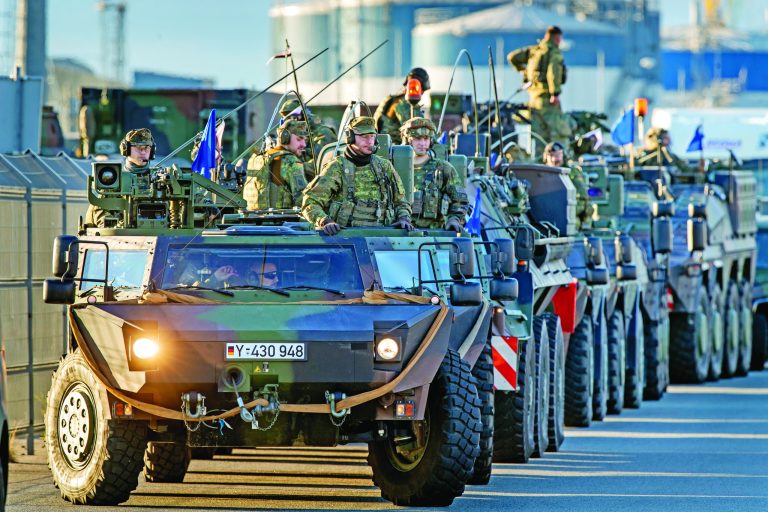 Members of a German Panzer division unload military vehicles as they arrive at the seaport of Klaipeda, Lithuania, Sept. 4, 2022.