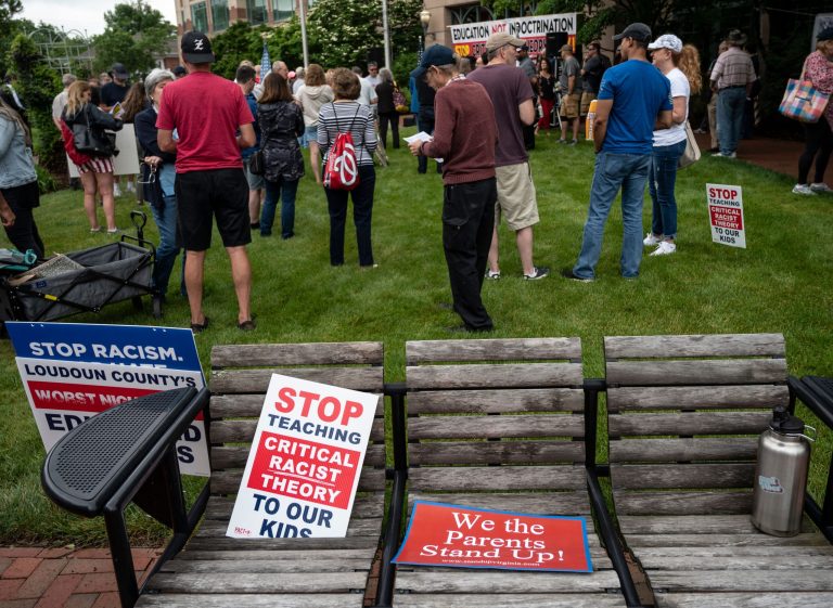 Signs are seen on a bench during a rally against 