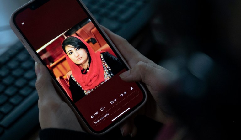 A woman looks at a picture of former Afghan lawmaker Mursal Nabizada on her mobile phone, who was shot dead by gunmen last night at her house in Kabul on Jan. 15, 2023. Mursal Nabizada had been a member of parliament in the previous Western-backed regime who had turned down the opportunity to flee Afghanistan when the Taliban seized power in August 2021. 