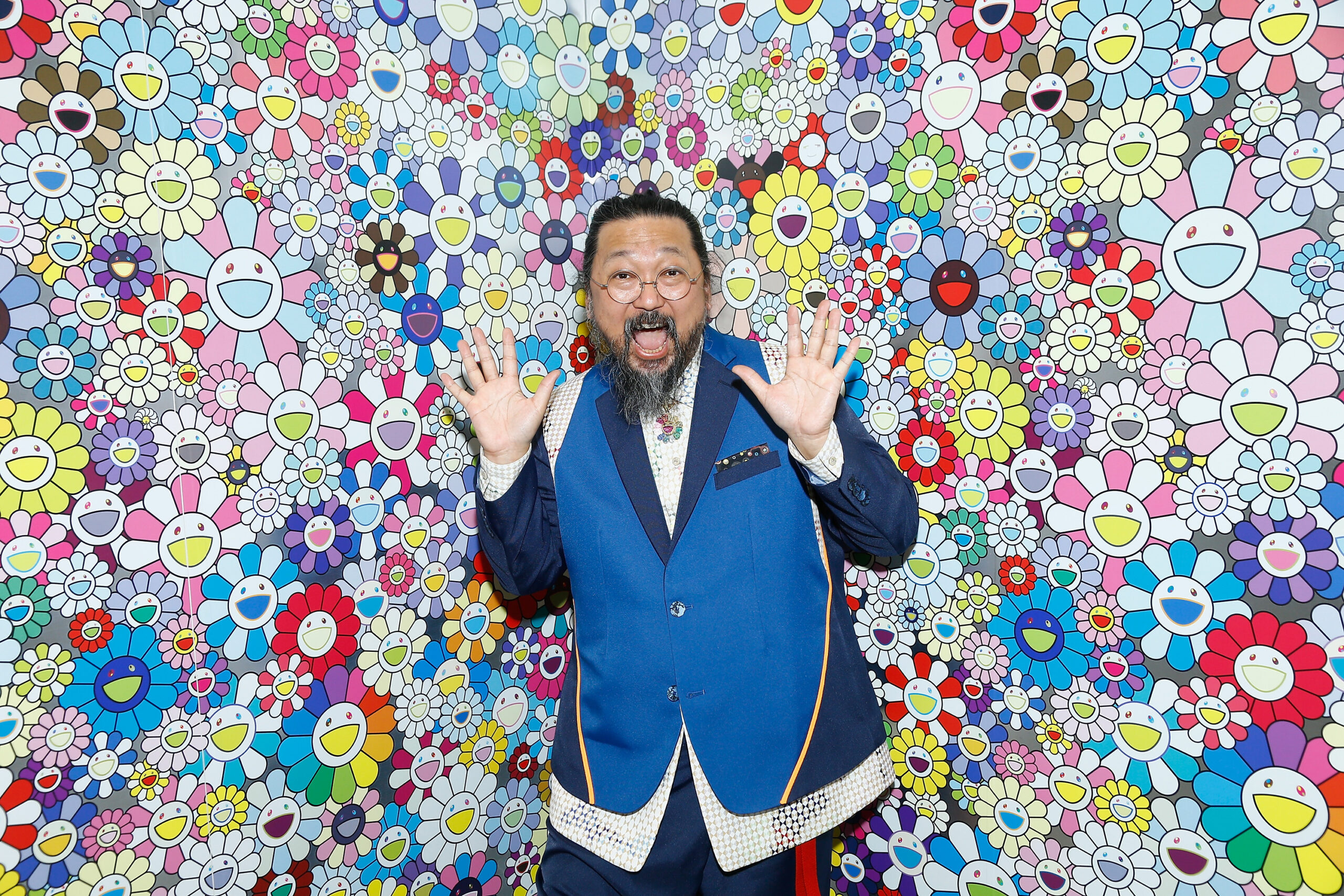 Takashi Murakami photographed with his signature smiling flowers in Paris in April 2018.