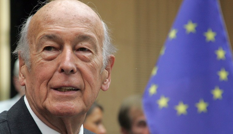 In this May 27, 2005 file photo, former French President Valery Giscard d'Estaing, with an EU Flag at right, attends the debate of the new European constitution at the German Upper House Bundesrat in Berlin.  Valery Giscard dâEstaing, the president of France from 1974 to 1981 who became a champion of European integration, has died Wednesday, Dec. 2, 2020 at the age of 94, his office and the French presidency said. 