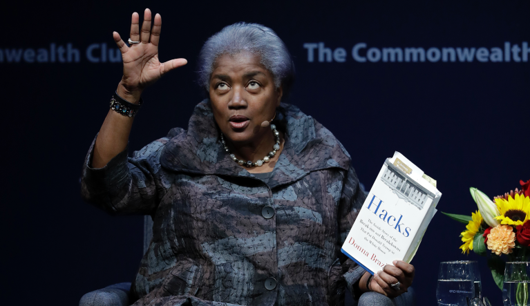 Former Democratic National Committee chair Donna Brazile holds a copy of her book Hacks, detailing the hacking of the DNC, during a meeting of The Commonwealth Club Thursday, Nov. 9, 2017, in San Francisco. (AP Photo/Marcio Jose Sanchez)