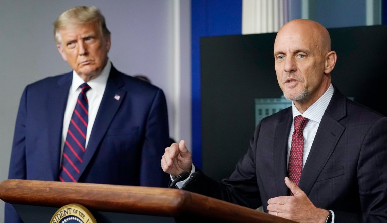 FILE - In this Aug. 23, 2020, file photo, President Donald Trump listens as Dr. Stephen Hahn, commissioner of the U.S. Food and Drug Administration, speaks during a media briefing in the James Brady Briefing Room of the White House in Washington. The credibility of two top public health agencies is on the line after controversial decisions that outside experts say suggest political pressure from the Trump administration. Hahn was forced to apologize for using an erroneous, misleading statistic describing the effectiveness of a blood plasma therapy granted emergency use for COVID-19, as Trump twisted the facts and inflated the significance of the move. 