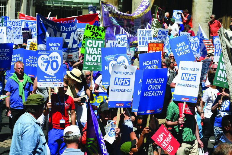 People march in central London to mark the 70th anniversary of the forming of the National Health Service (NHS), Saturday June 30, 2018. Various unions and interested groups gathered Saturday to celebrate the forming of the NHS and call for better funding for the British health service. (John Stillwell/PA via AP)