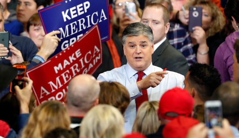 Television personality Sean Hannity speaks to members of the audience while signing autographs before the start of a campaign rally Monday, Nov. 5, 2018, in Cape Girardeau, Mo., with President Donald Trump. 