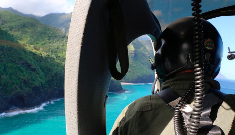 This photo provided by the Hawaii Department of Land and Natural Resources shows a Coast Guard search and rescue team looking over Napali Coast State Wilderness Park for a tour Helicopter that disappeared in Hawaii with seven people aboard on Friday, Dec. 27, 2019. Authorities say the helicopter's owner called for help about 45 minutes after the chopper was due back from a tour of Kauai's Na Pali Coast on Thursday evening.
