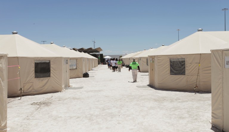 The undated photo released by U.S. Department of Health and Human Services shows detainees walk in a line at the HHS' unaccompanied alien children program facility at Tornillo, Texas.
