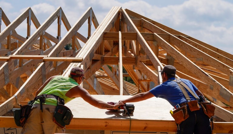 Business economists expect more economic growth and a soft landing. Workers build a home Tuesday, Sept. 19, 2023, in Marshall, N.C. Climate change is increasing billion-dollar disasters, many of them from intensifying hurricanes. Housing developers are now building homes, some of them round, that can resist hurricane-force winds and at the same time generate much less of the emissions that contribute to climate change.