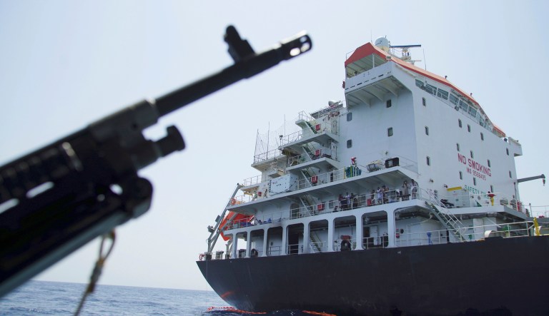 Sailors stand on deck above a hole the U.S. Navy says was made by a limpet mine on the damaged Panama-flagged, Japanese owned oil tanker Kokuka Courageous, anchored off Fujairah, United Arab Emirates, during a trip organized by the Navy for journalists, Wednesday, June 19, 2019.