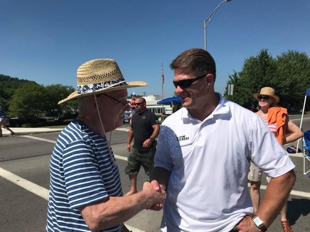 Pennsylvania state Rep. Tim O'Neal (pictured right), a Republican, talks to people at an event. O'Neal is trying to defend his seat against Clark Mitchell Jr., his Democratic opponent, in November.