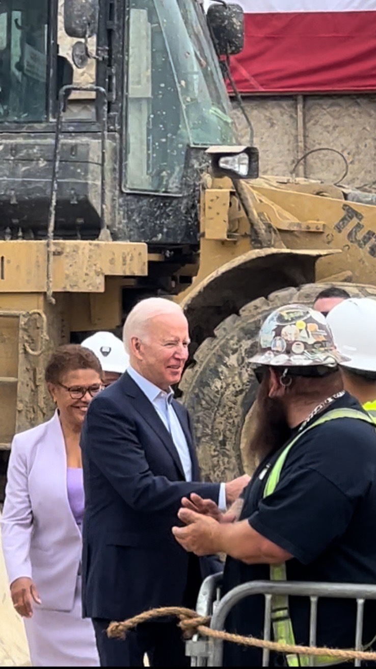 President Joe Biden visits a VA property with Rep. Karen Bass to promote a parking lot for a new subway extension.