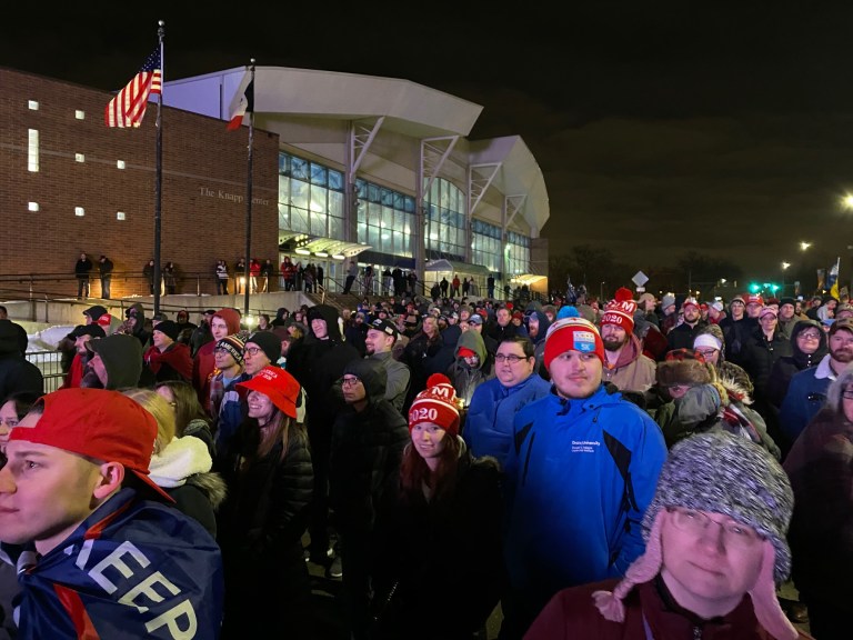 Supporters watch President Trump's Des Moines rally on a big screen outside the Knapp Center at Drake University.