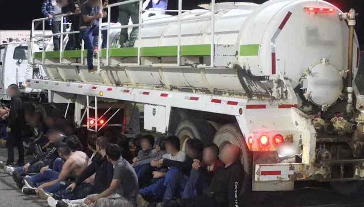 Smugglers caught in Texas trying to transport 50 migrants hidden inside ...
